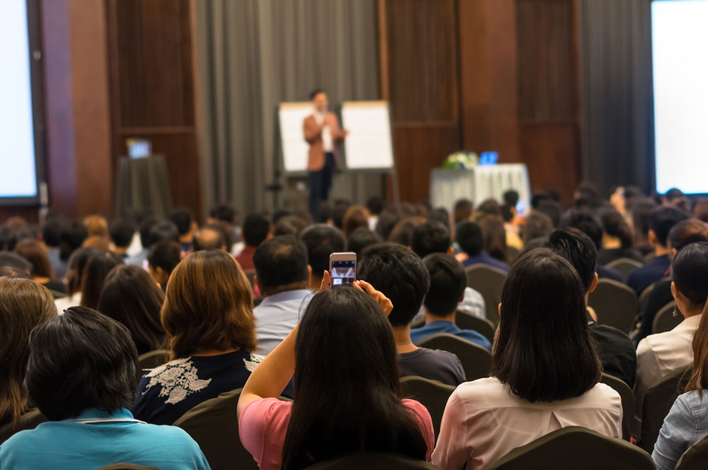 Crowd of people listening to seminar at a corporate event