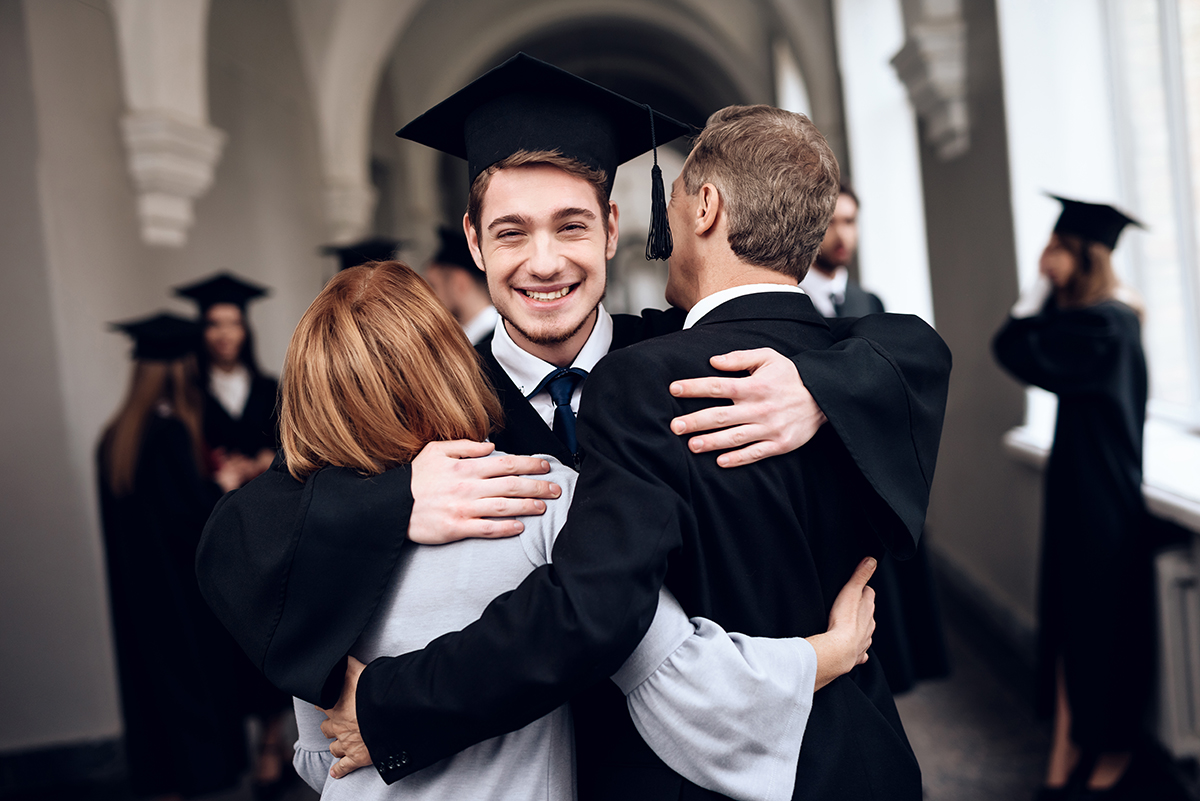 Student hugs parents after graduation