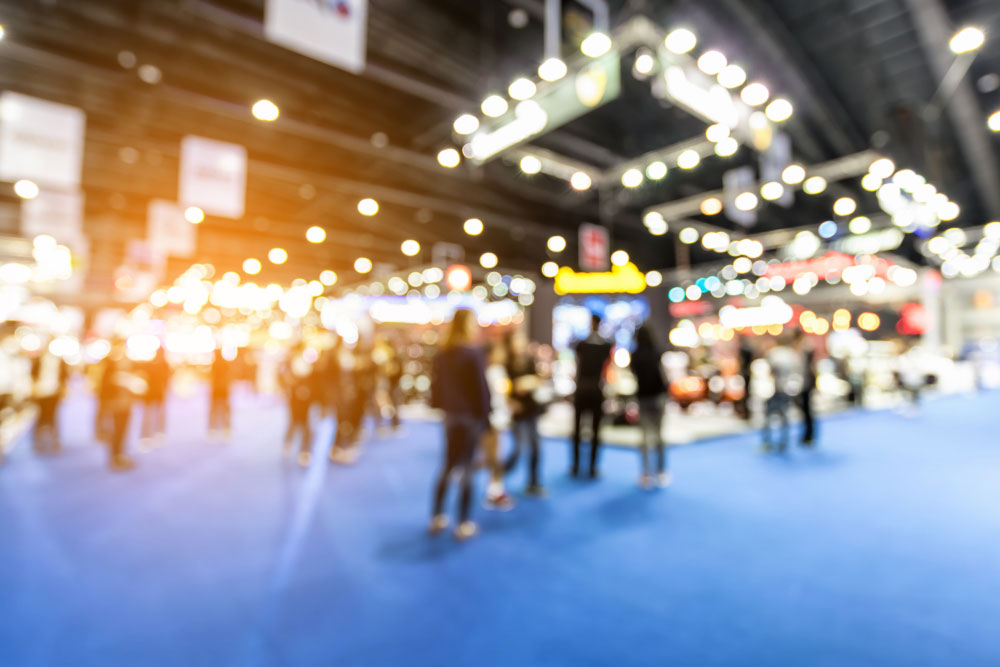 Blurred image of people walking through a trade show