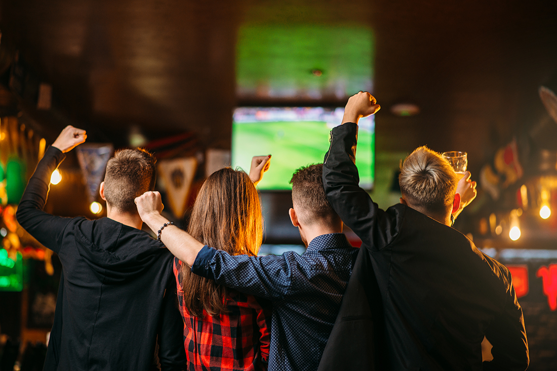 Friends watching a game at a sports bar