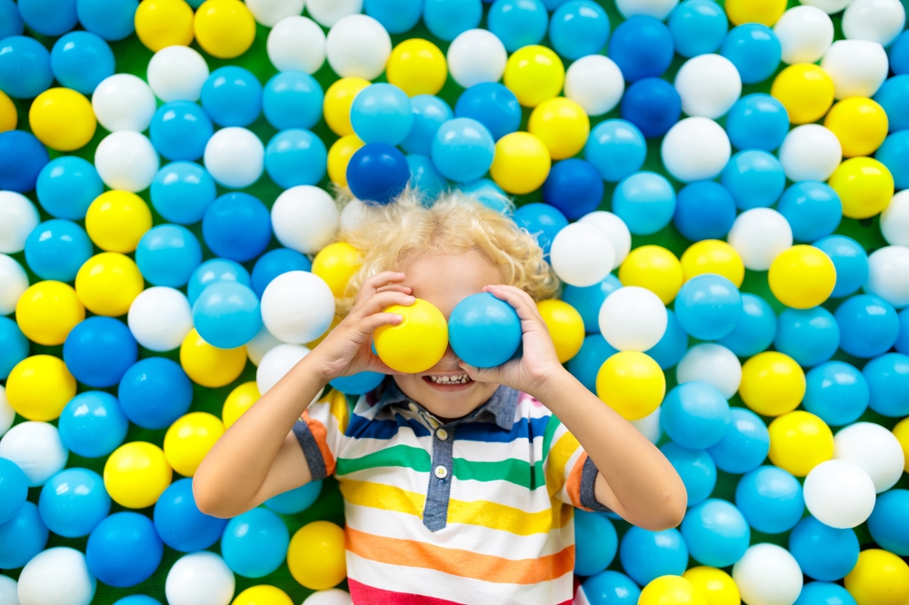 Child playing in a colorful ball pit in Rocky Mount, NC