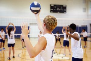 Male volleyball player serving volleyball