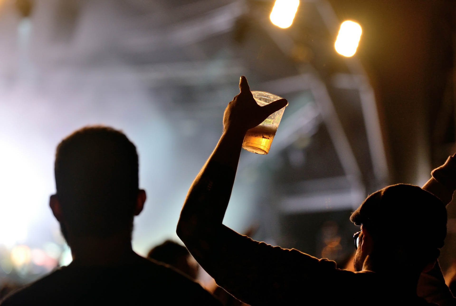 guest watching concert and holding a drink