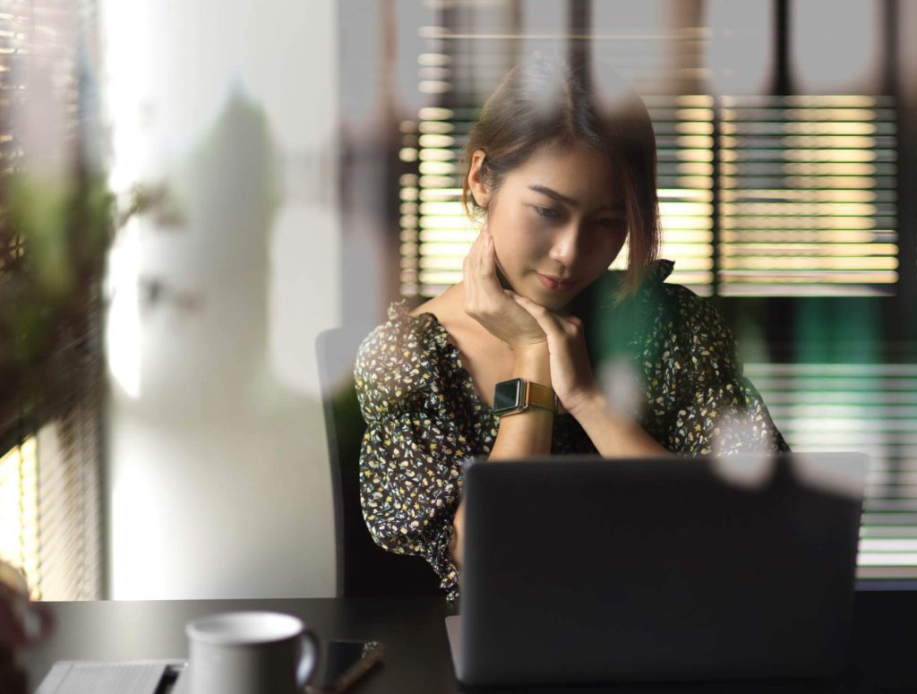 woman looking at her computer